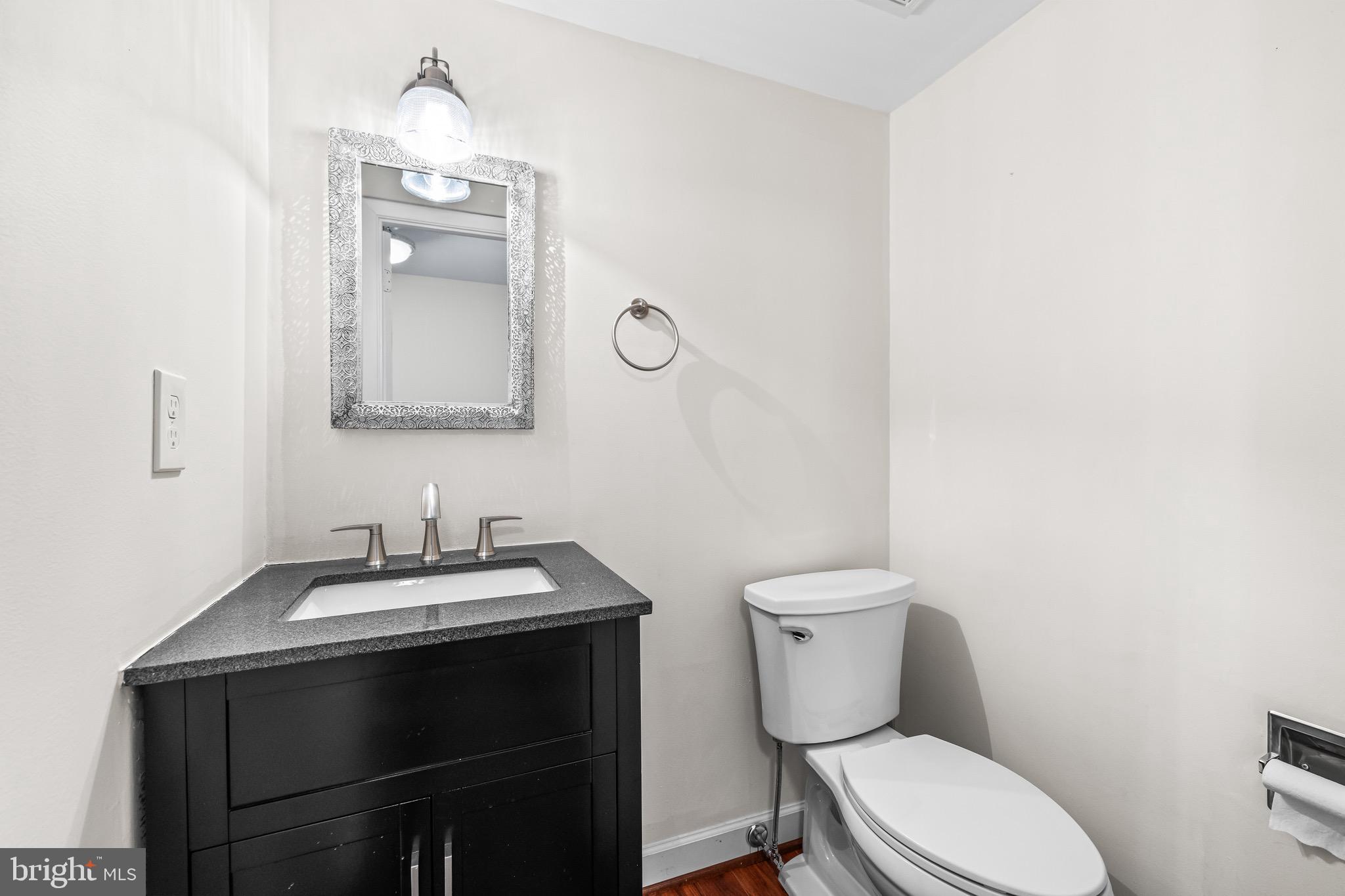 11 Tanner Court, Unit G Baltimore, MD 21208 - Photo 5 of 38 a bathroom with a toilet a sink and mirror