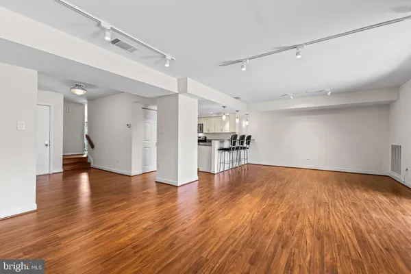 a view of empty room with wooden floor