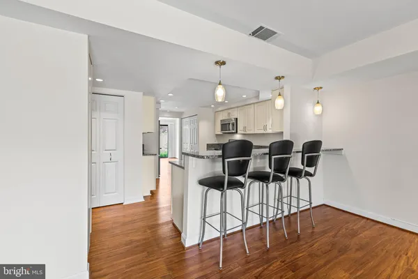 a view of a dining room with furniture and wooden floor