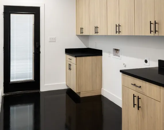 a kitchen with granite countertop white cabinets and black appliances