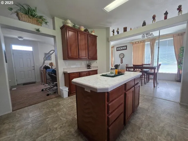 a kitchen with a sink a table and chairs in it