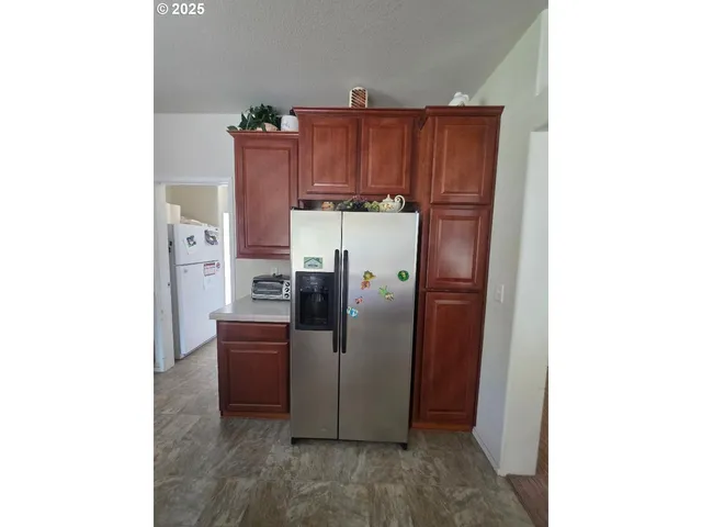 a kitchen with refrigerator and cabinets