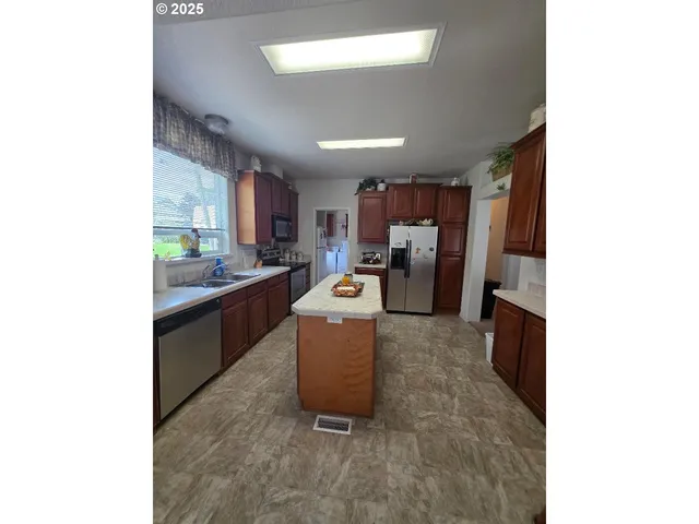 a kitchen with refrigerator and cabinets