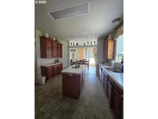 a kitchen with sink a stove and cabinets