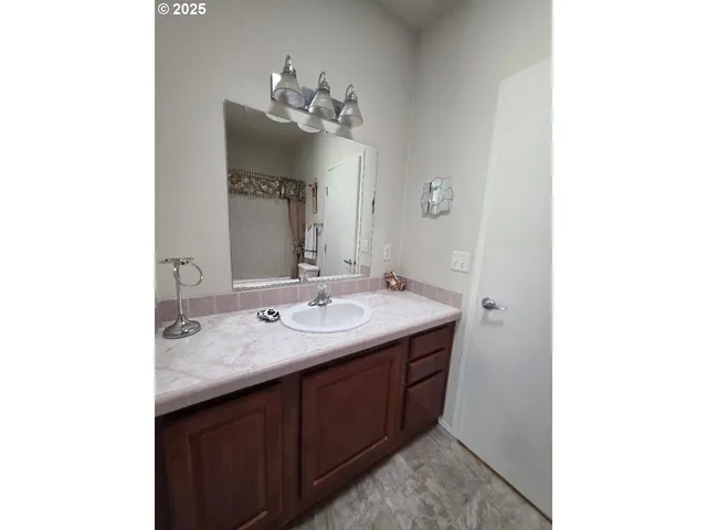a bathroom with a double vanity sink and a mirror