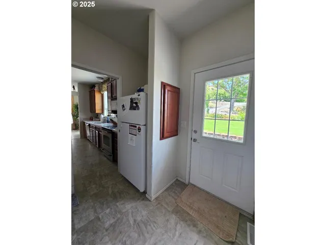 a view of a kitchen from the hallway