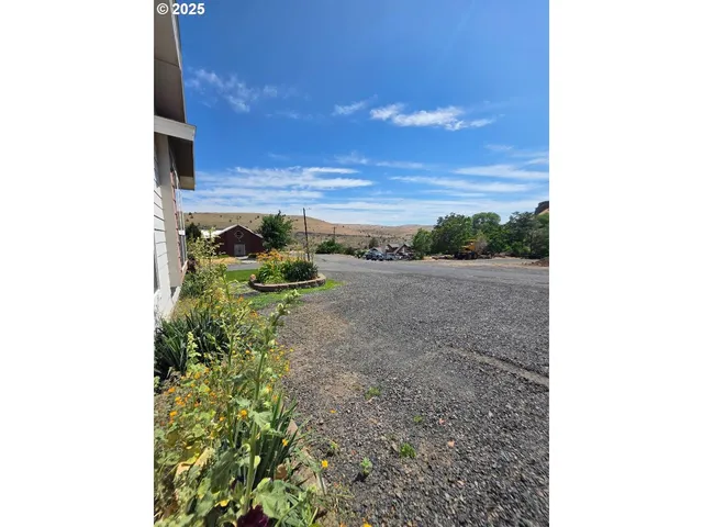 a view of a backyard with sitting area