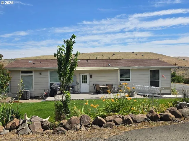 a front view of a house with a garden and patio