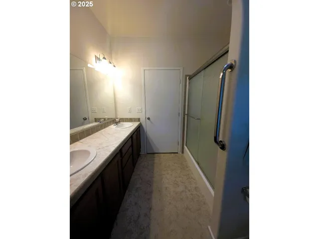 a bathroom with a shower and a window