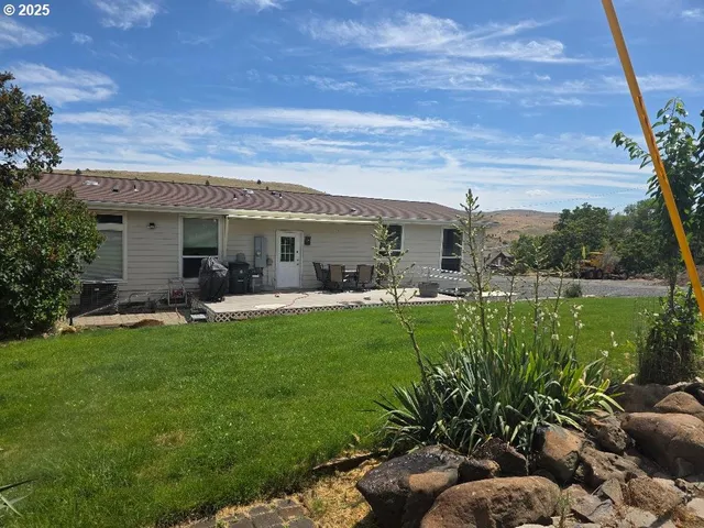 a front view of house with a garden