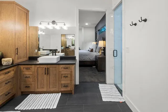 a very nice looking room with a large mirror and a sink