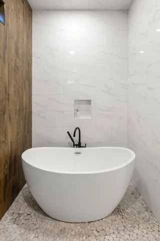 a white tub sitting next to a white sink