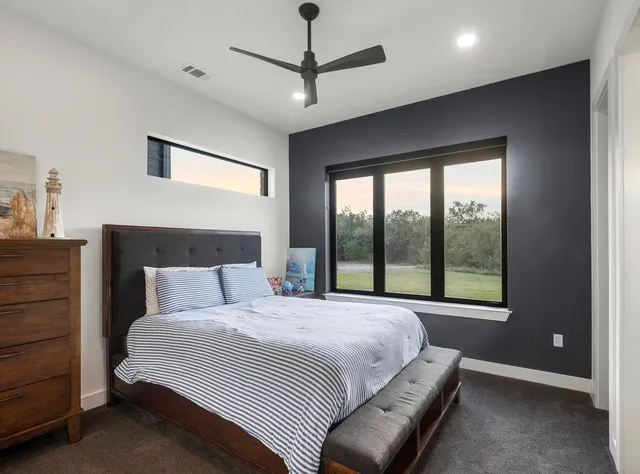 a bedroom with a large bed and a window