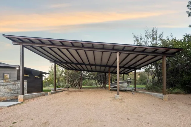 a backyard of a house with table and chairs