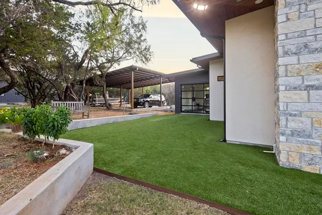 a view of a patio with table and chairs under an umbrella