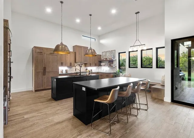 a kitchen with a table chairs and a chandelier