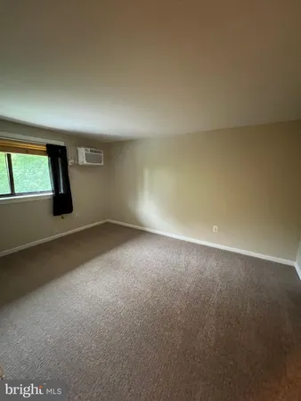 an empty room with a empty space and windows