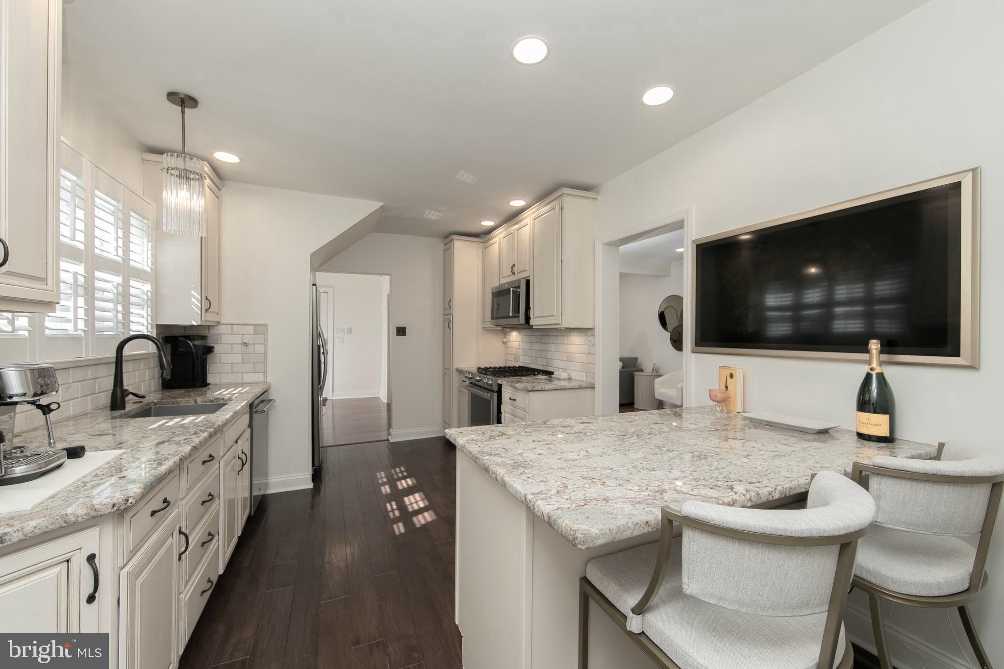 401 Spruce Street Haddonfield, NJ 08033 - Photo 16 of 40 a kitchen with granite countertop a sink and chairs