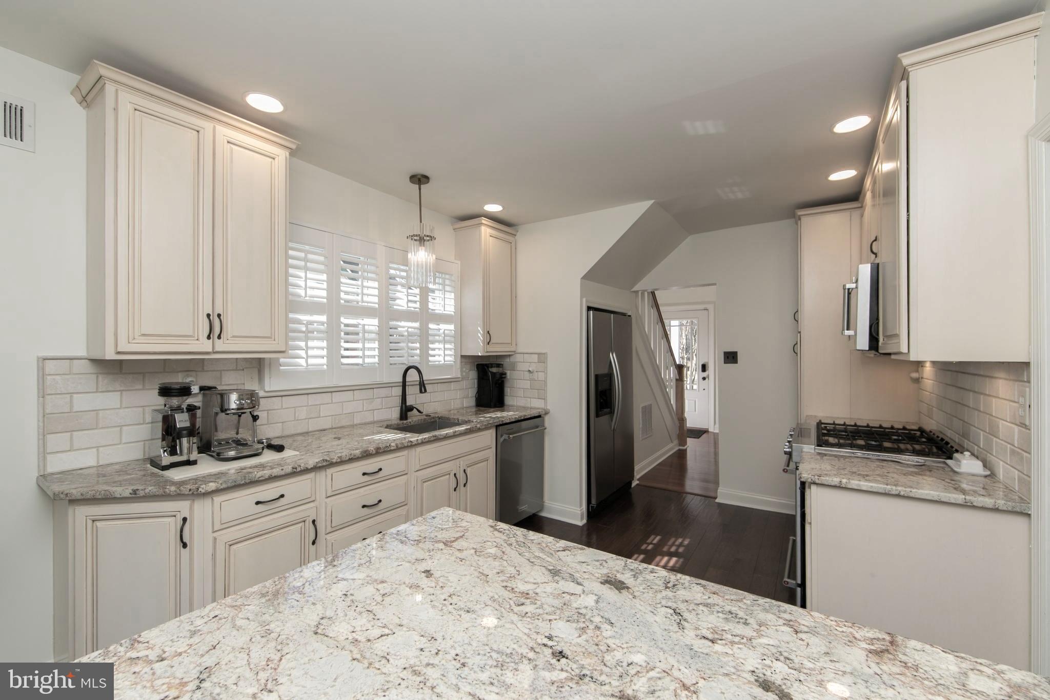 401 Spruce Street Haddonfield, NJ 08033 - Photo 17 of 40 a kitchen with stainless steel appliances kitchen island granite countertop a sink stove and refrigerator