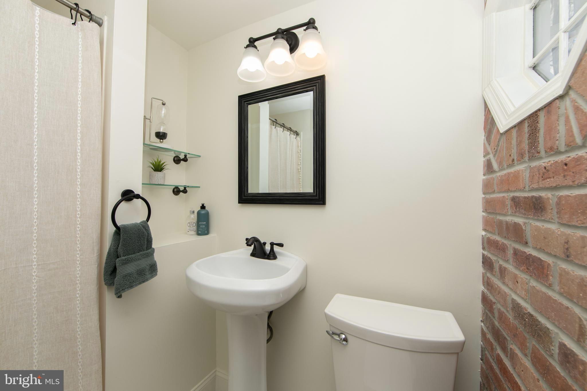 401 Spruce Street Haddonfield, NJ 08033 - Photo 22 of 40 a bathroom with a toilet sink and mirror