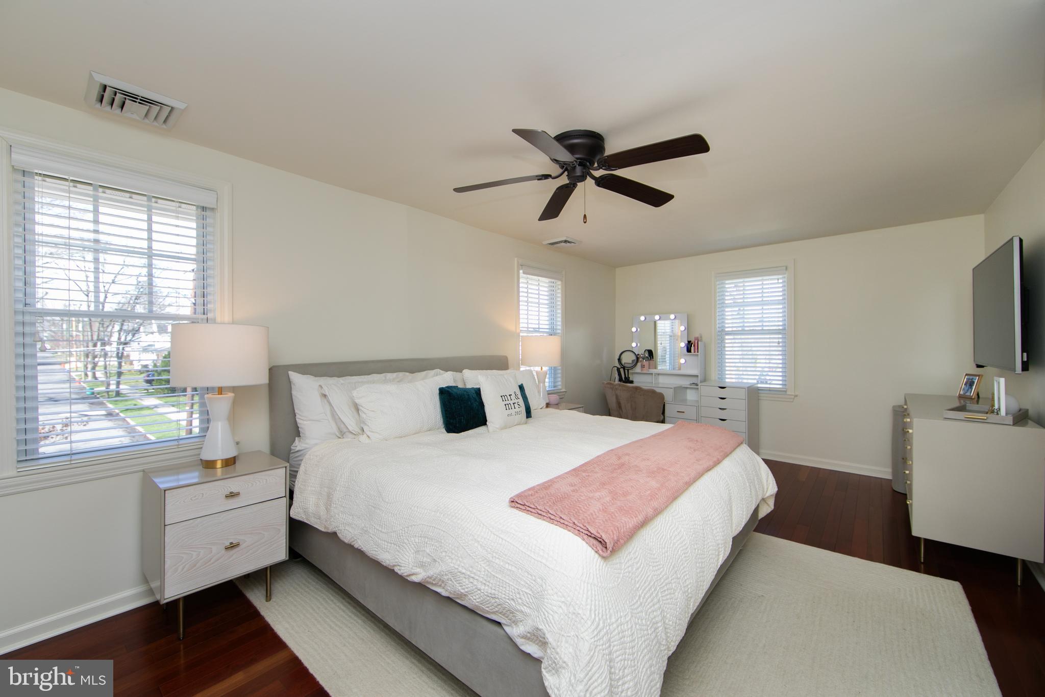 401 Spruce Street Haddonfield, NJ 08033 - Photo 24 of 40 a bedroom with a large bed and a flat tv screen on dresser