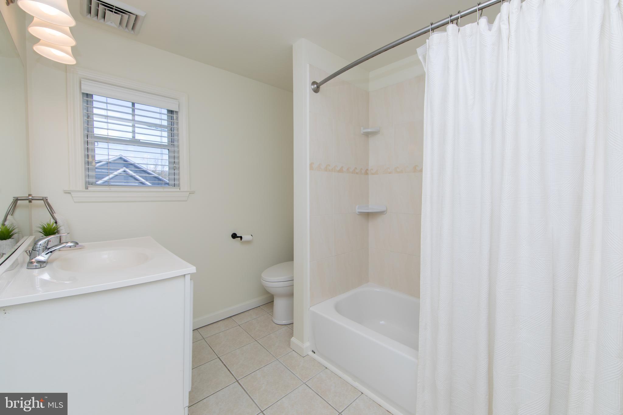 401 Spruce Street Haddonfield, NJ 08033 - Photo 29 of 40 a bathroom with a sink a toilet and shower