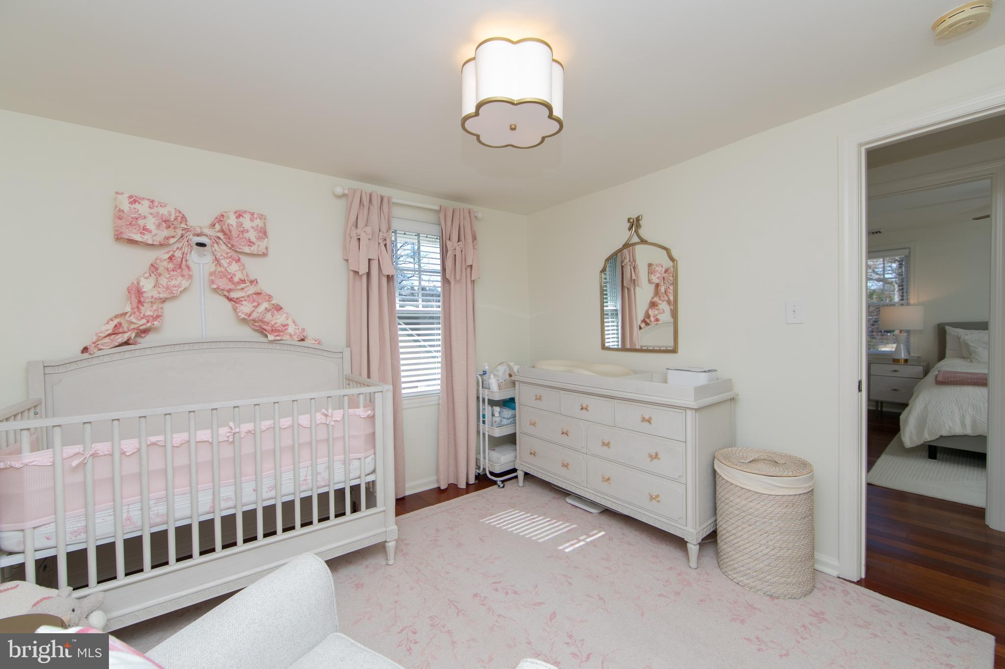 401 Spruce Street Haddonfield, NJ 08033 - Photo 32 of 40 a room with baby crib and dresser