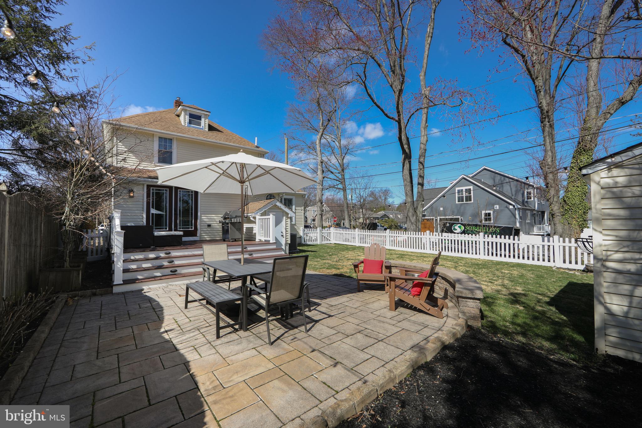 401 Spruce Street Haddonfield, NJ 08033 - Photo 38 of 40 a view of a patio with table and chairs under an umbrella