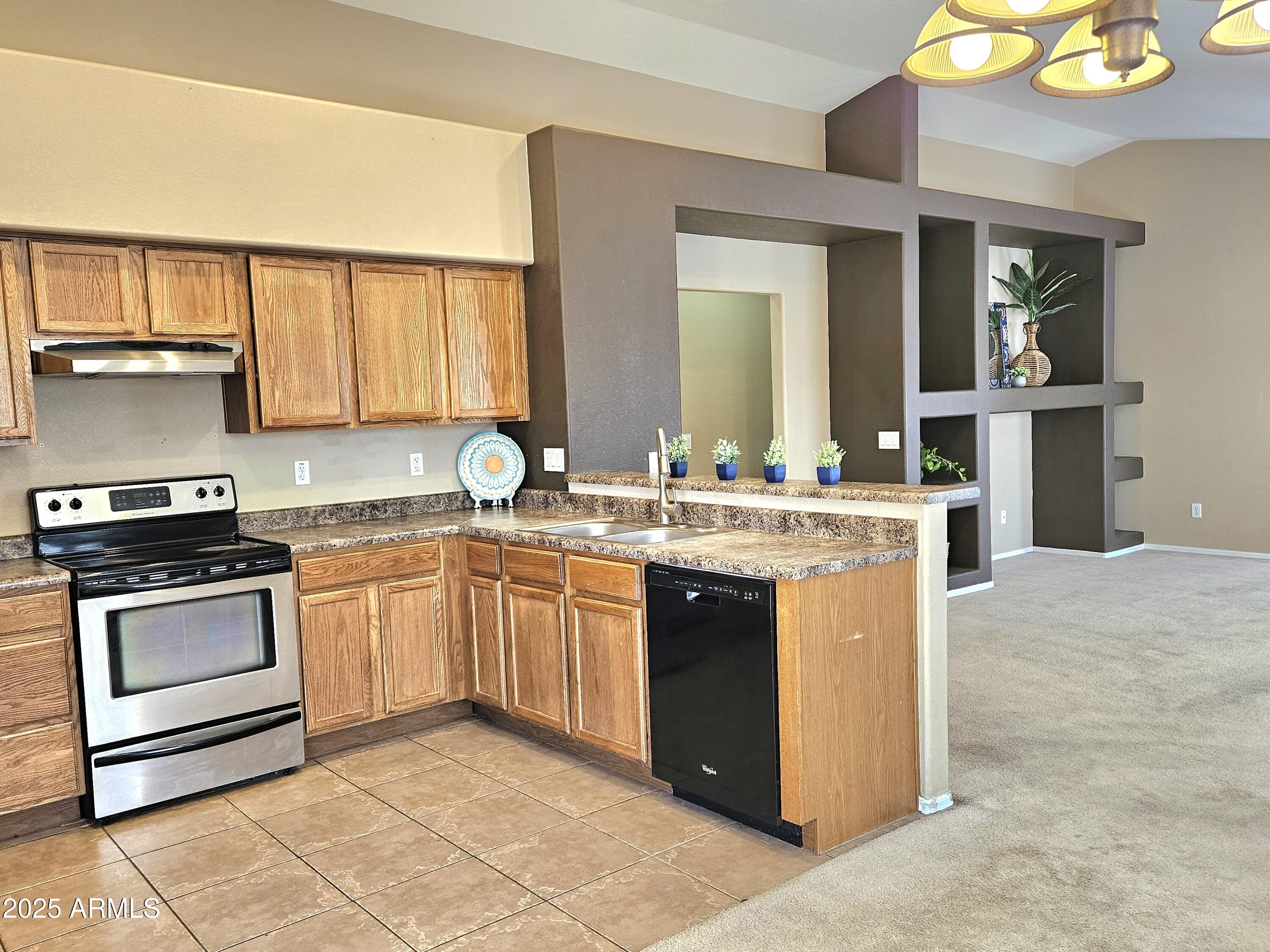 592 East 9th Avenue Apache Junction, AZ 85119 - Photo 5 of 19 a kitchen with stainless steel appliances granite countertop a sink stove and cabinets