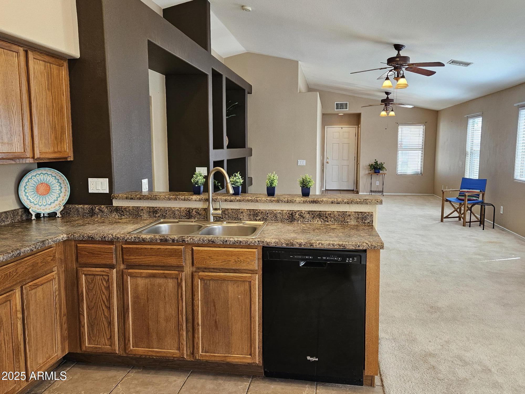 592 East 9th Avenue Apache Junction, AZ 85119 - Photo 6 of 19 a bathroom with a granite countertop sink a large mirror and a vanity
