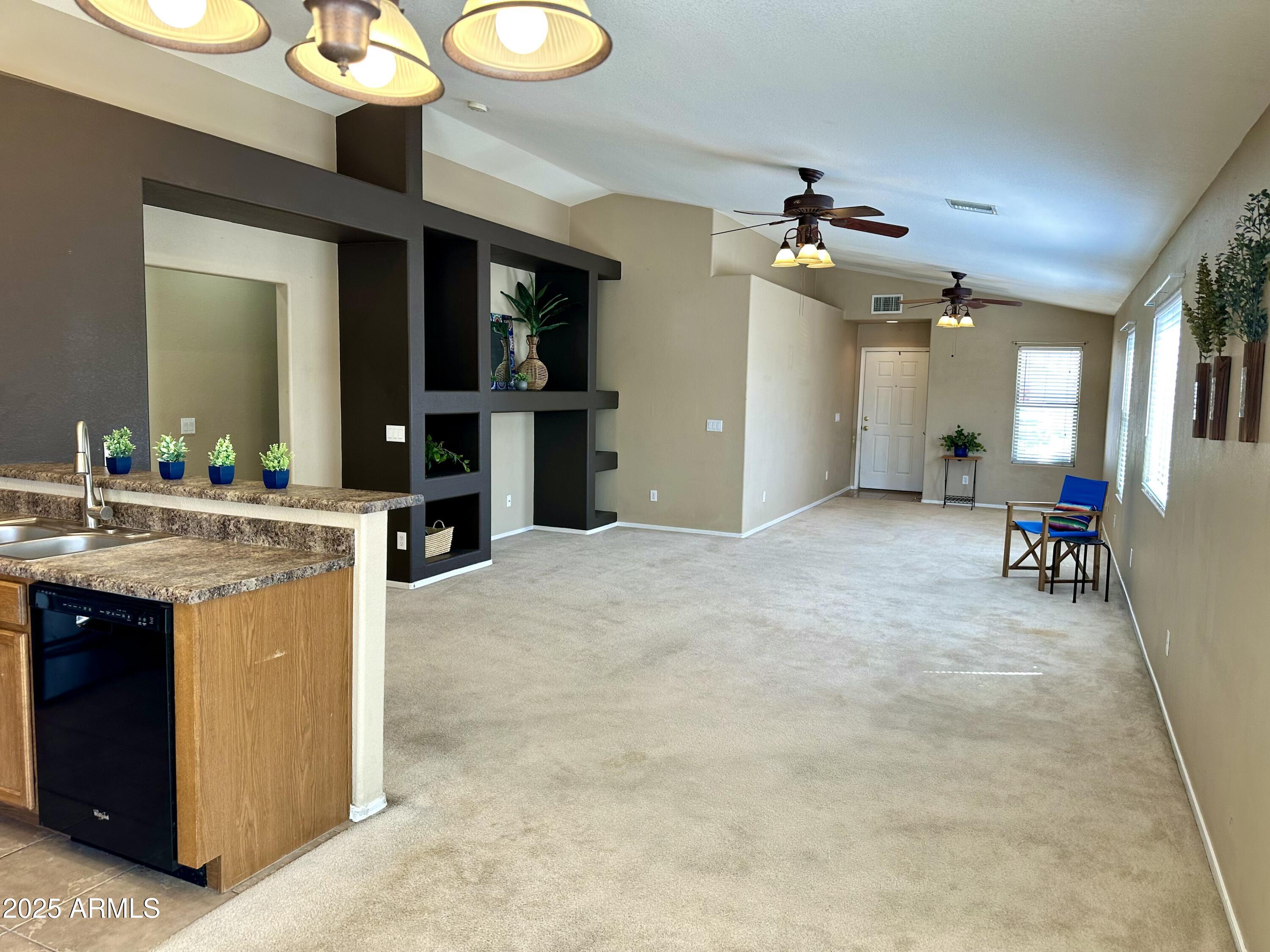 592 East 9th Avenue Apache Junction, AZ 85119 - Photo 7 of 19 a view of a kitchen center island and stainless steel appliances
