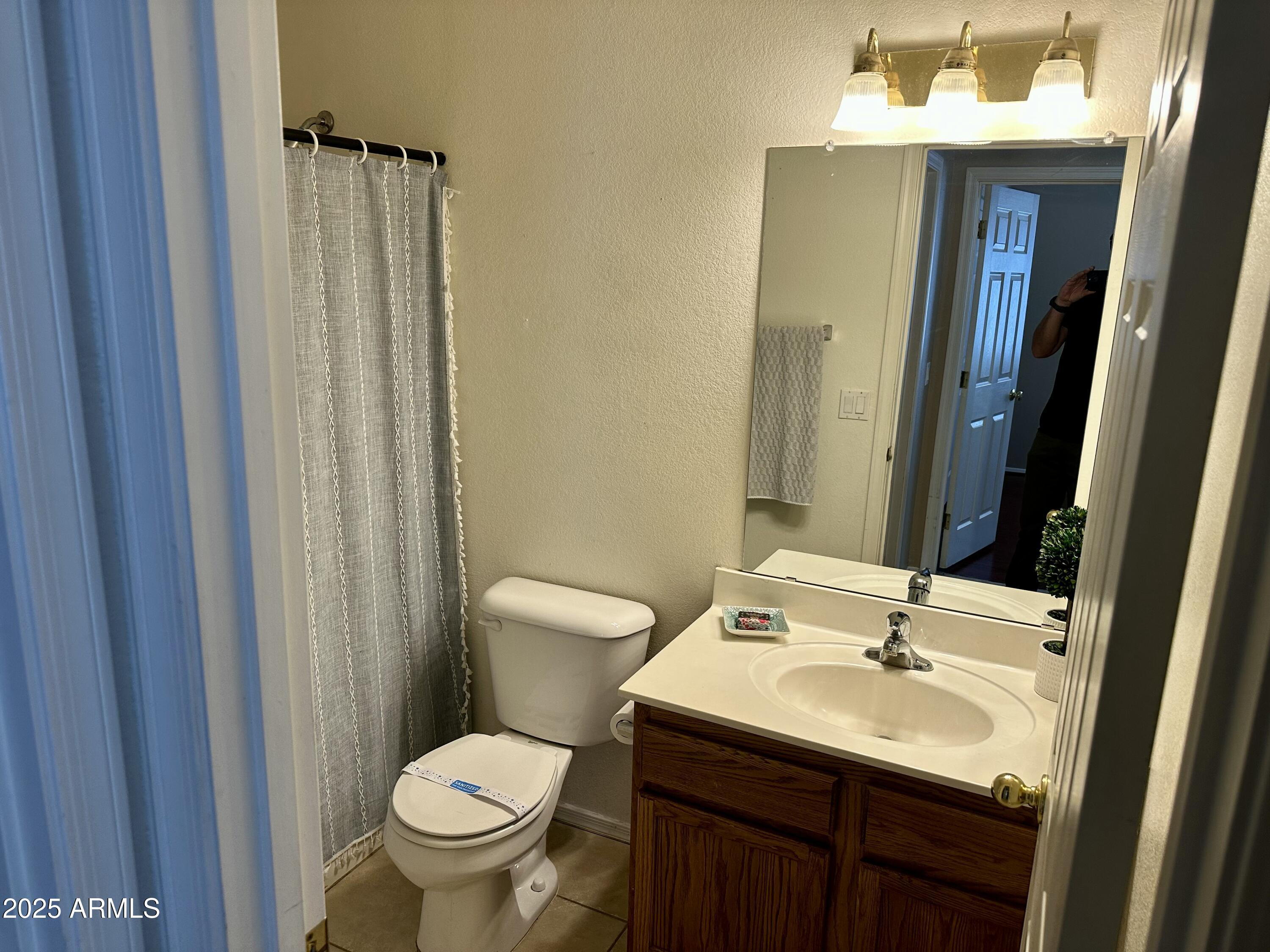 592 East 9th Avenue Apache Junction, AZ 85119 - Photo 10 of 19 a bathroom with a toilet sink and mirror