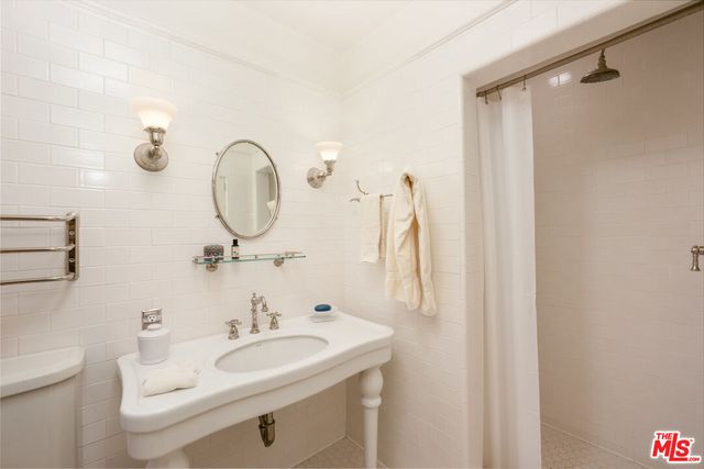 a bedroom with a bed couch and a window