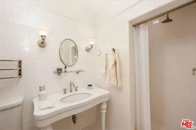 a bedroom with a bed couch and a window