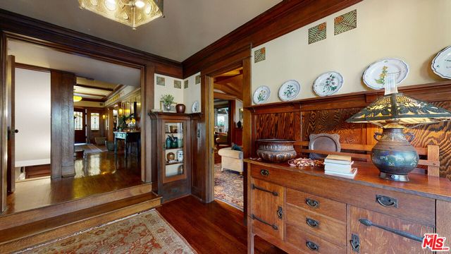 a view of backyard with table and chairs and large trees