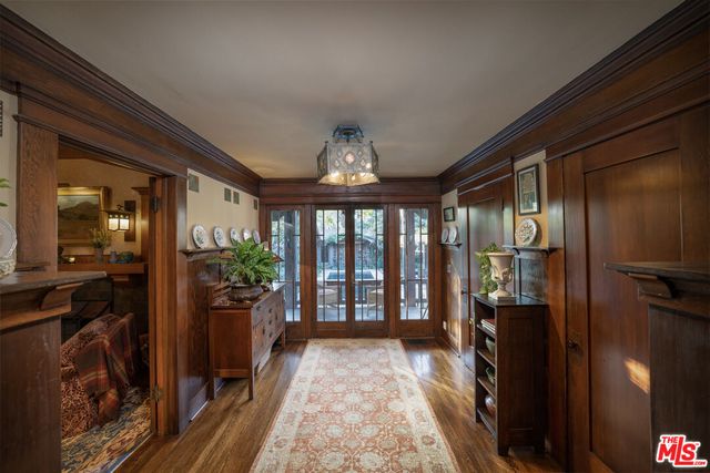 a backyard of a house with fountain table and chairs