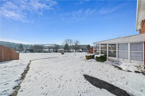 a view of living room filled with furniture and floor to ceiling window