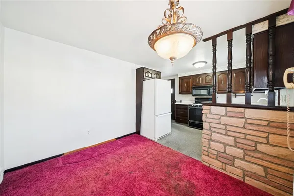 a kitchen with stainless steel appliances granite countertop a stove microwave and cabinets