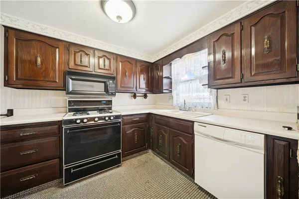 a view of a room with wooden floor and furniture