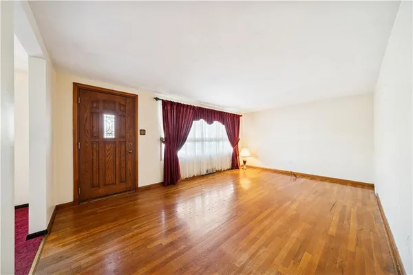 a view of an empty room and wooden floor