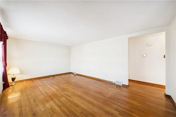 a view of a bedroom with a bed and a window