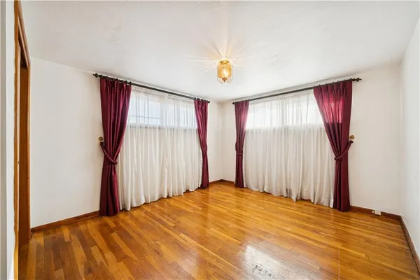 a view of a room with wooden floor and windows