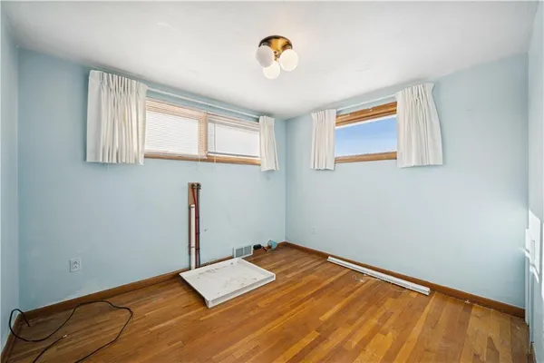a view of a room with a hanging light and kitchen