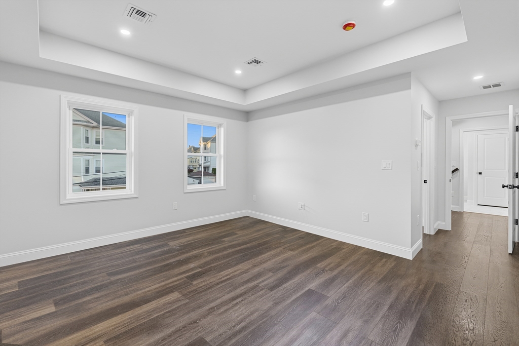 138 18th Street Fall River, MA 02723 - Photo 12 of 14 a view of an empty room with wooden floor and a window