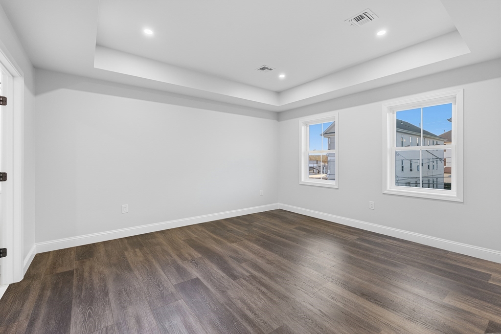 138 18th Street Fall River, MA 02723 - Photo 13 of 14 an empty room with wooden floor and windows