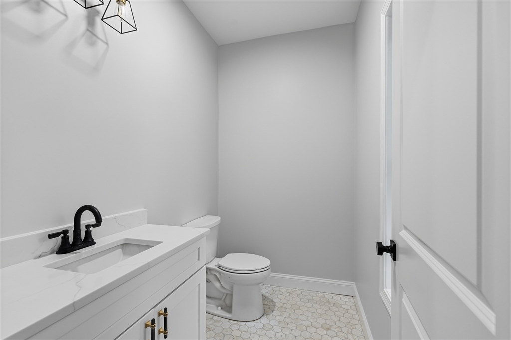 138 18th Street Fall River, MA 02723 - Photo 8 of 14 a bathroom with a toilet a sink and mirror