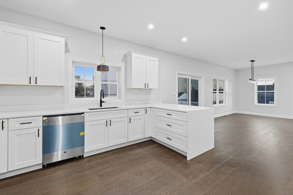 138 18th Street Fall River, MA 02723 - Photo 9 of 14 a kitchen with white cabinets and white appliances