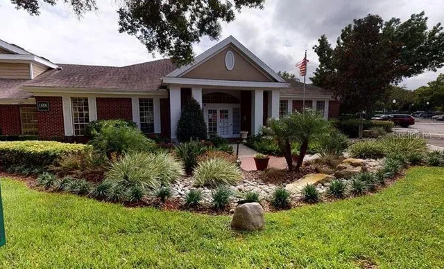 a front view of a house with a yard and outdoor seating