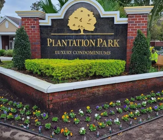 a sign that is sitting in front of flowers