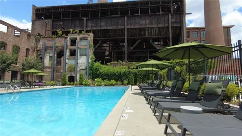 a view of a patio with couches table and chairs and potted plants